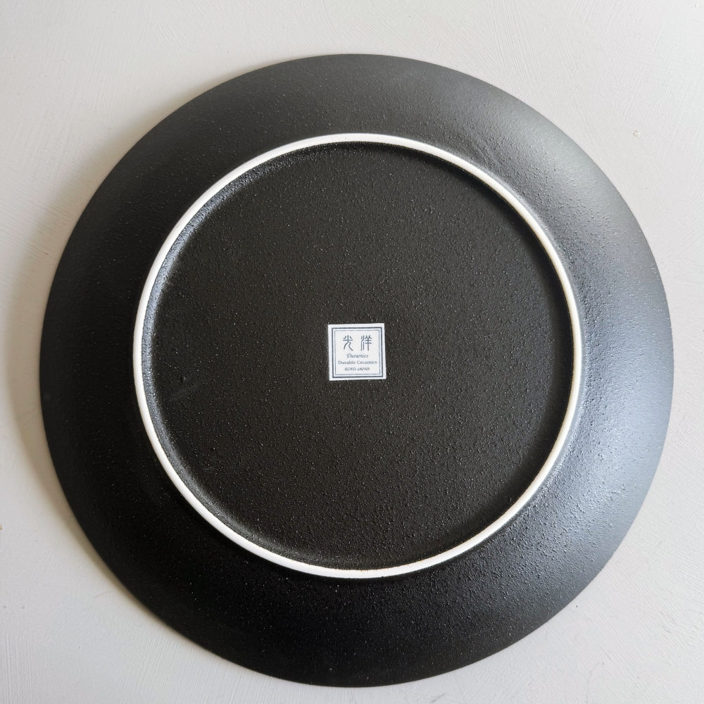 Hakeme dinner plate in black glaze. Mino ware, made in Japan. Available at Toka Ceramics.