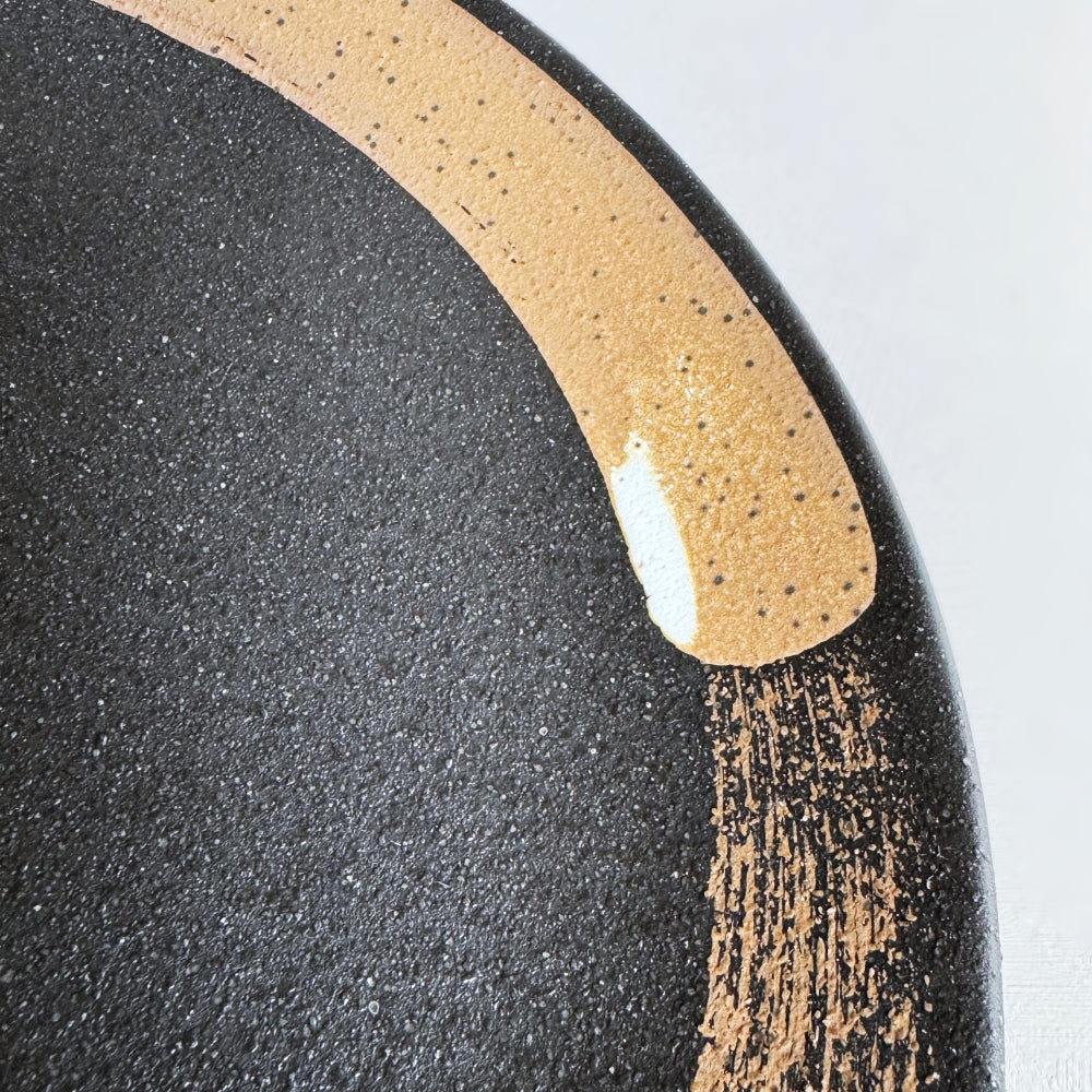 Hakeme dinner plate in black glaze. Mino ware, made in Japan. Available at Toka Ceramics.