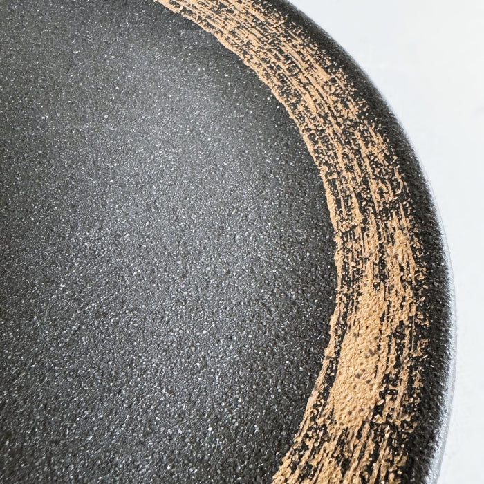 Hakeme dinner plate in black glaze. Mino ware, made in Japan. Available at Toka Ceramics.