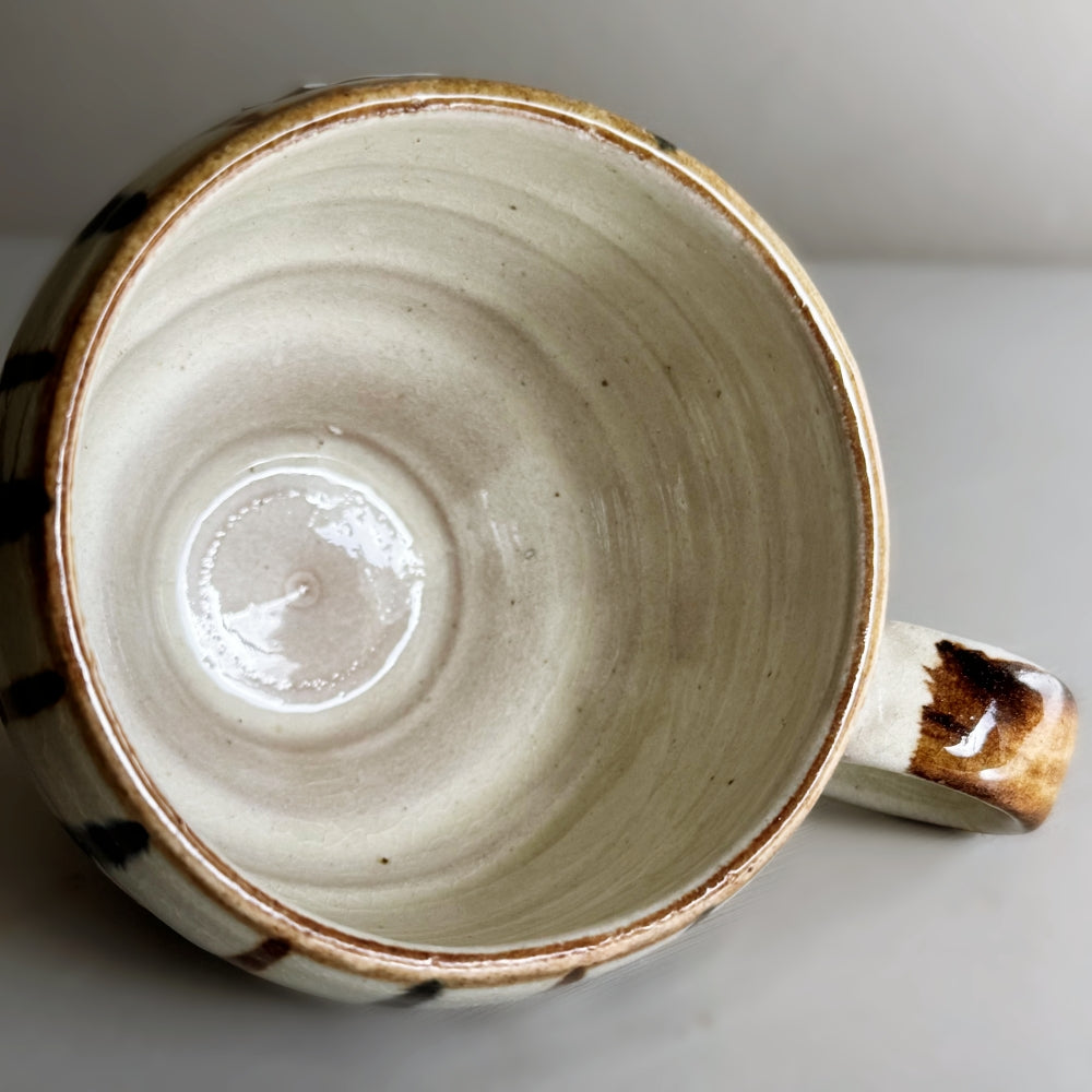 Japanese pottery rounded mug with foot ring with navy and brown tokusa pattern. Mino ware, made in Japan. Available at Toka ceramics.