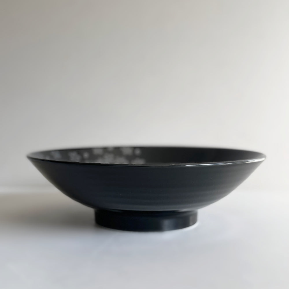 Black Mino ware bowl with cherry blossom motifs, made in Japan. Available at Toka Ceramics.