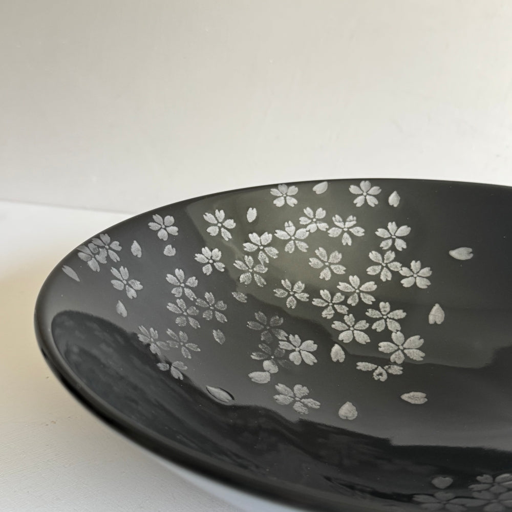 Black Mino ware bowl with cherry blossom motifs, made in Japan. Available at Toka Ceramics.