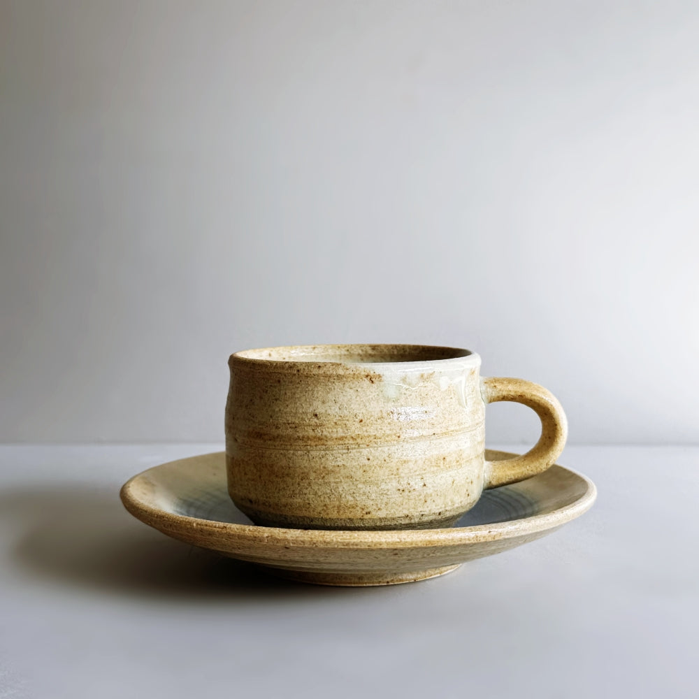 Sandy colour, blue glass glazed cup and saucer set. Handcrafted Japanese pottery, made in Japan. Available at Toka Ceramics.
