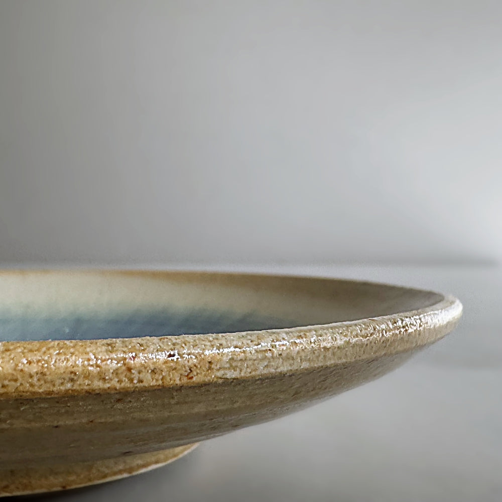 Sandy colour, blue glass glazed cup and saucer set. Handcrafted Japanese pottery, made in Japan. Available at Toka Ceramics.