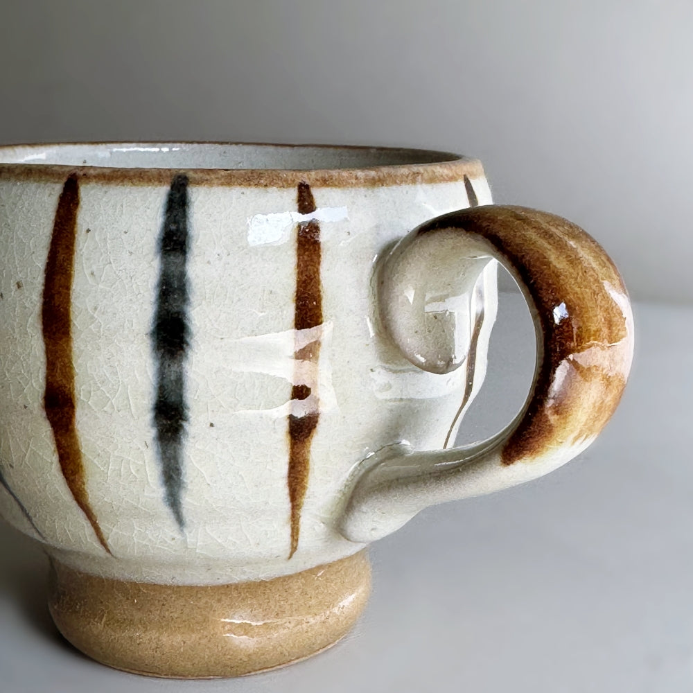 Japanese pottery rounded mug with foot ring with navy and brown tokusa pattern.  Mino ware, made in Japan. Available at Toka ceramics.