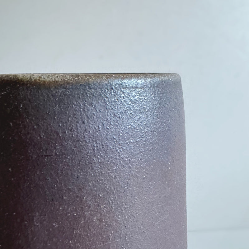 An earthy brown vase handcrafted by Tsugaru Kanayama Pottery in Japan. Large cylinder shape. Available at Toka Ceramics.