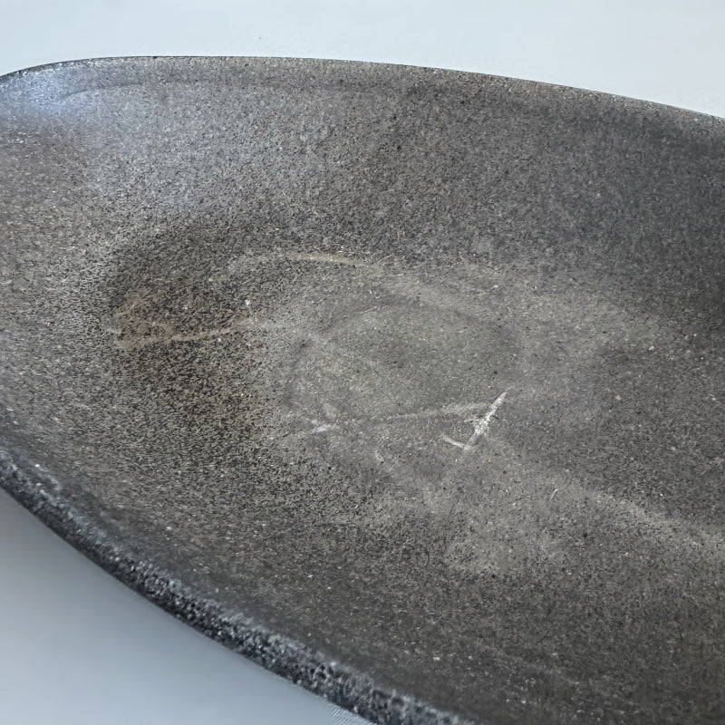 handcrafted Tsugaru Sueki Oval Shallow Bowls made in Japan, featuring a minimalist design with smooth, unglazed dark surfaces.