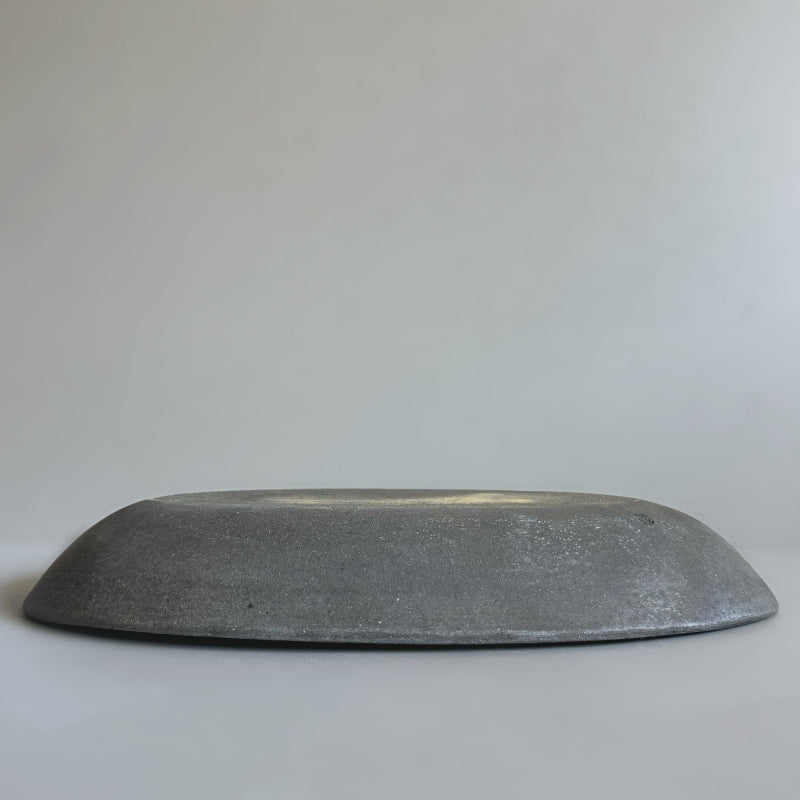 handcrafted Tsugaru Sueki Oval Shallow Bowls made in Japan, featuring a minimalist design with smooth, unglazed dark surfaces.