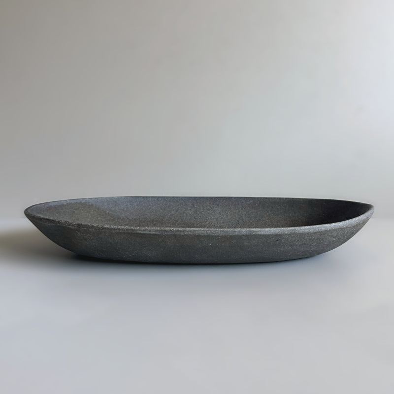 handcrafted Tsugaru Sueki Oval Shallow Bowls made in Japan, featuring a minimalist design with smooth, unglazed dark surfaces.