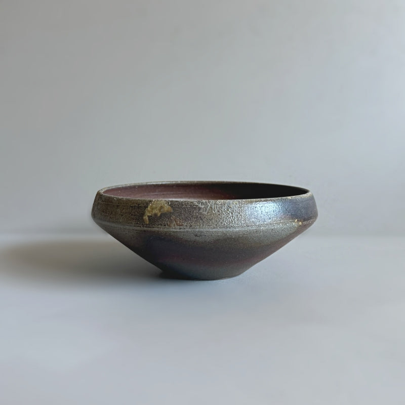 An earthy brown medium sized bowl without glaze. Handcrafted by Tsugaru Kanayama Pottery in Japan. Available at Toka Ceramics.