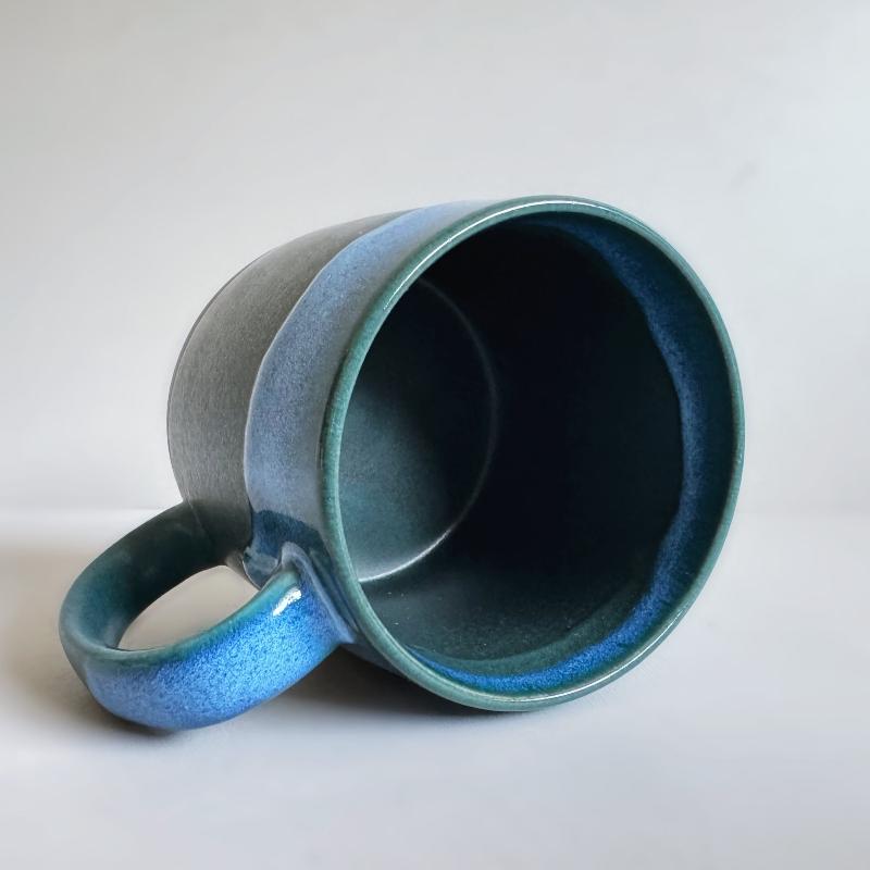 Inside of TOKA ceramic mug featuring a vibrant blue and deep green dripping glaze, handmade Mino ware from Japan.